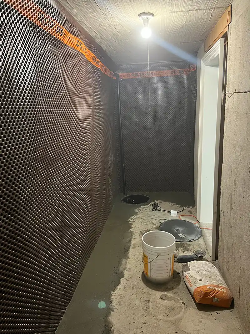 room with interior waterproofing on the foundation walls and sump pump installed